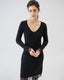 Model wearing a black long-sleeve dress with lace trim on a white background