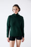 Model wearing black merino wool-blend knitted shorts and dark green merino wool turtleneck jumper.