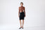 Model wearing a black merino skirt on a white background