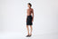 Woman wearing a black merino skirt on a white background