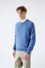 Model wearing blue merino-cashmere blend crew neck jumper, side view.