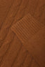 Detailed view of braided cable knit pattern on brown merino-cashmere blend turtleneck jumper.
