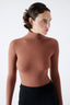 Woman wearing a brown merino bodysuit