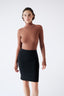 Woman wearing a brown merino bodysuit