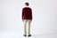 Model wearing burgundy cashmere V-neck jumper with beige trousers, back view.