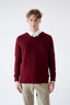 Model wearing burgundy cashmere V-neck jumper with beige trousers, front view.
