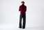 Model wearing burgundy merino wool turtleneck jumper, back view.