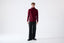 Model wearing burgundy merino wool turtleneck jumper, full-body front view.