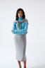 Model wearing a grey skirt on a white background