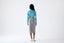 Model wearing a grey skirt on a white background