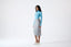 Model wearing a grey skirt on a white background