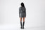 Model wearing a grey sweater and matching shorts on a white background