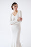 Close-up of model wearing ivory merino-alpaca long-sleeve dress with V-neckline by Roksolana.