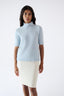 Model wearing light blue merino wool short-sleeve turtleneck jumper.