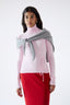 Model wearing light grey merino wool-angora triangle scarf with pink jumper and red skirt, front view.