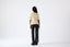 Model wearing a light yellow short-sleeve wool jumper, back view.