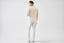 Model wearing cream merino-cashmere blend crew neck jumper, back view.