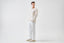 Model wearing cream merino-cashmere blend crew neck jumper with matching trousers, back view.