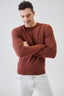 Close-up of terracotta merino wool knit jumper on a model