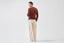 Model wearing terracotta merino wool jumper, back view