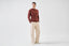 Model wearing terracotta merino wool crew neck jumper by Roksolana