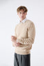 Model wearing beige merino wool crew neck jumper with white shirt by Roksolana.