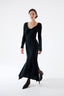 Woman wearing a black dress on a white background