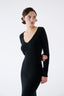 Woman wearing a black dress against a white background