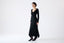 Model wearing a black dress on a white background