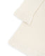 Close-up of fluffy decorative details on an ivory merino wool dress