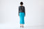 Model wearing Turquoise Ribbed Wool Midi Skirt by Roksolana, back view.