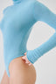 Model wearing a sky blue merino wool turtleneck bodysuit, detail view