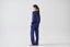 Model wearing cobalt blue merino wool-blend knitted trousers with matching jumper, side view.