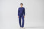 Model wearing cobalt blue merino wool-blend knitted trousers with matching jumper, front view.