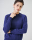 Model wearing cobalt blue merino wool-blend crew neck jumper, close-up view.