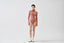 Model wearing a warm brown merino bodysuit on a white background