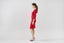 Model wearing red merino wool knitted pencil skirt with matching cardigan, side view.