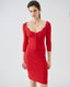 Model wearing red merino wool knitted pencil skirt with matching cardigan, front view.