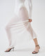 Close-up of model wearing white sheer mohair-alpaca knit maxi skirt showing fine texture and soft drape.