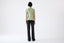 Model wearing a light green wool short-sleeve turtleneck jumper by Roksolana, back view.
