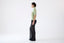 Model wearing a light green wool short-sleeve turtleneck jumper by Roksolana, side view.